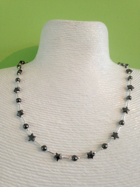 Silver and hematite star necklace. 18 inches in length.